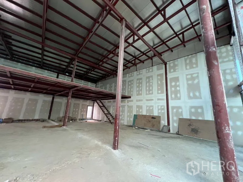 Retail Space for rent in Watthana, Bangkok - Interior view of open-plan unit with exposed steel beams and drywall.