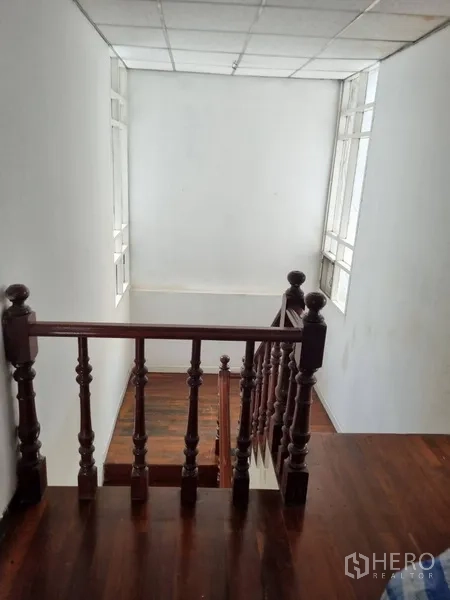 Detached House for rent or sale in Sathon, Bangkok - Top of staircase with tall side windows bringing natural light.