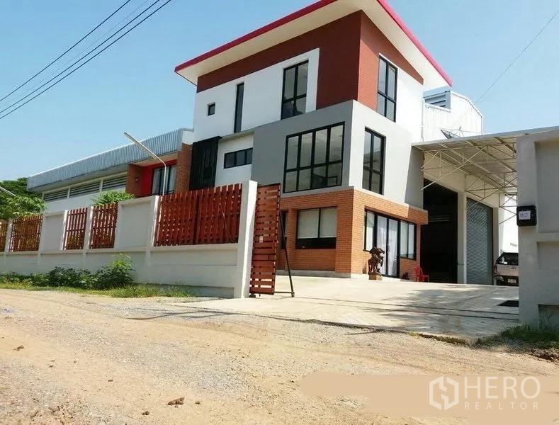 工厂 出租或出售在Lat Lum Kaeo, Pathum Thani - 现代化厂房与办公楼外观，红色屋顶、砖饰面与大门车道。