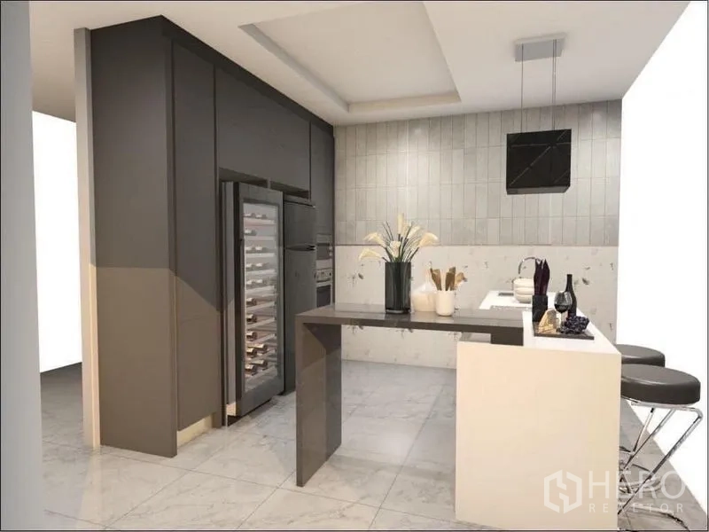 Detached House for sale in Suan Luang, Bangkok - Alternate angle of the kitchen with island bar, pendant lights, tiled floor and tall pantry cabinets.