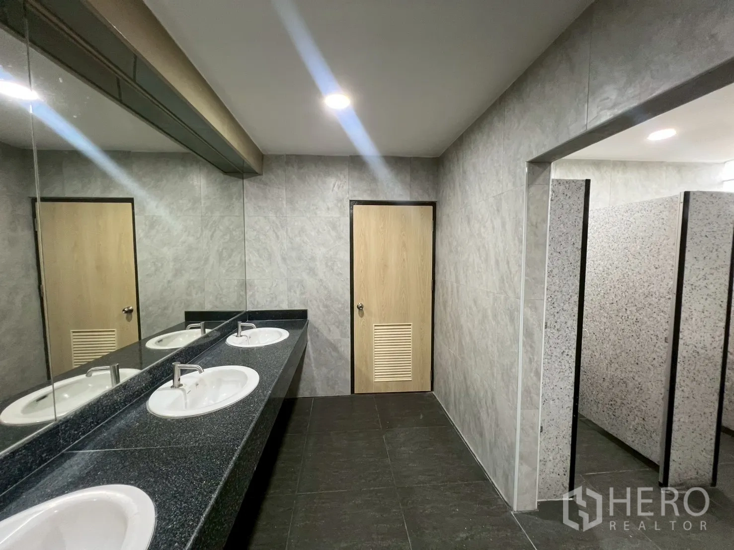 Office Space for rent in Watthana, Bangkok - Restroom vanity with long stone counter, mirrors and basins.