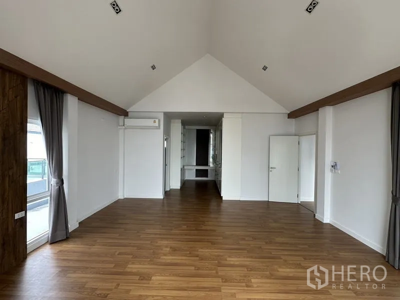 Detached House for sale in Lam Luk Ka, Pathum Thani - Master bedroom wide view across to the dressing alcove and doors.
