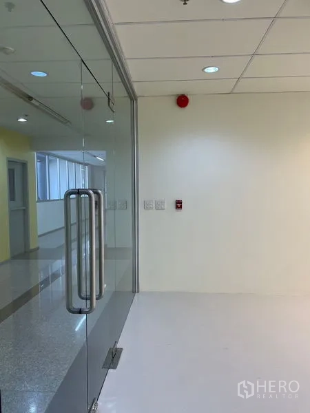 Office Space for rent in Watthana, Bangkok - Glass entry door with stainless handles leading into a bright office area.