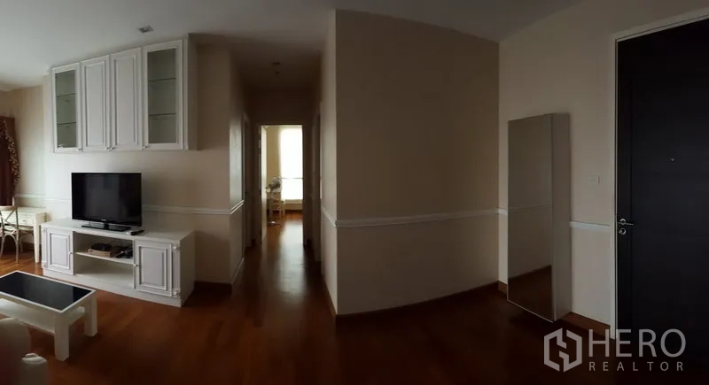 Condominium for rent in Bang Rak, Bangkok - Spacious entry and hallway leading to bedrooms, TV unit and full-length mirror, wood floors.