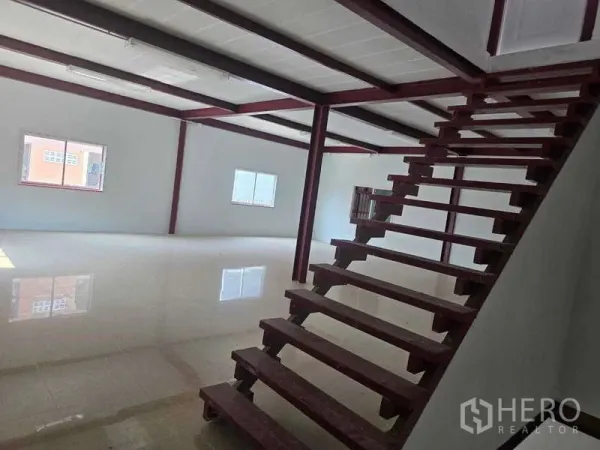 Warehouse for rent in Mueang Samut Sakhon, Samut Sakhon - Open mezzanine level with red steel beams and windows, viewed from the foot of the stairs.