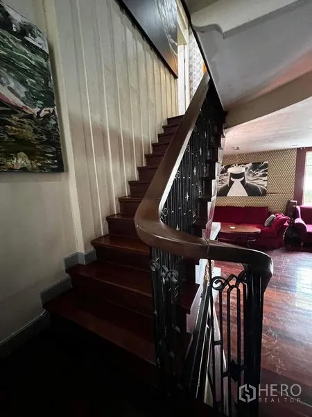 Townhouse for rent - Wood staircase with wrought-iron railing leading to upper floor.