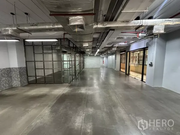 Office Space for rent - Open-plan loft office with polished concrete floors, glass meeting rooms and exposed ducting.