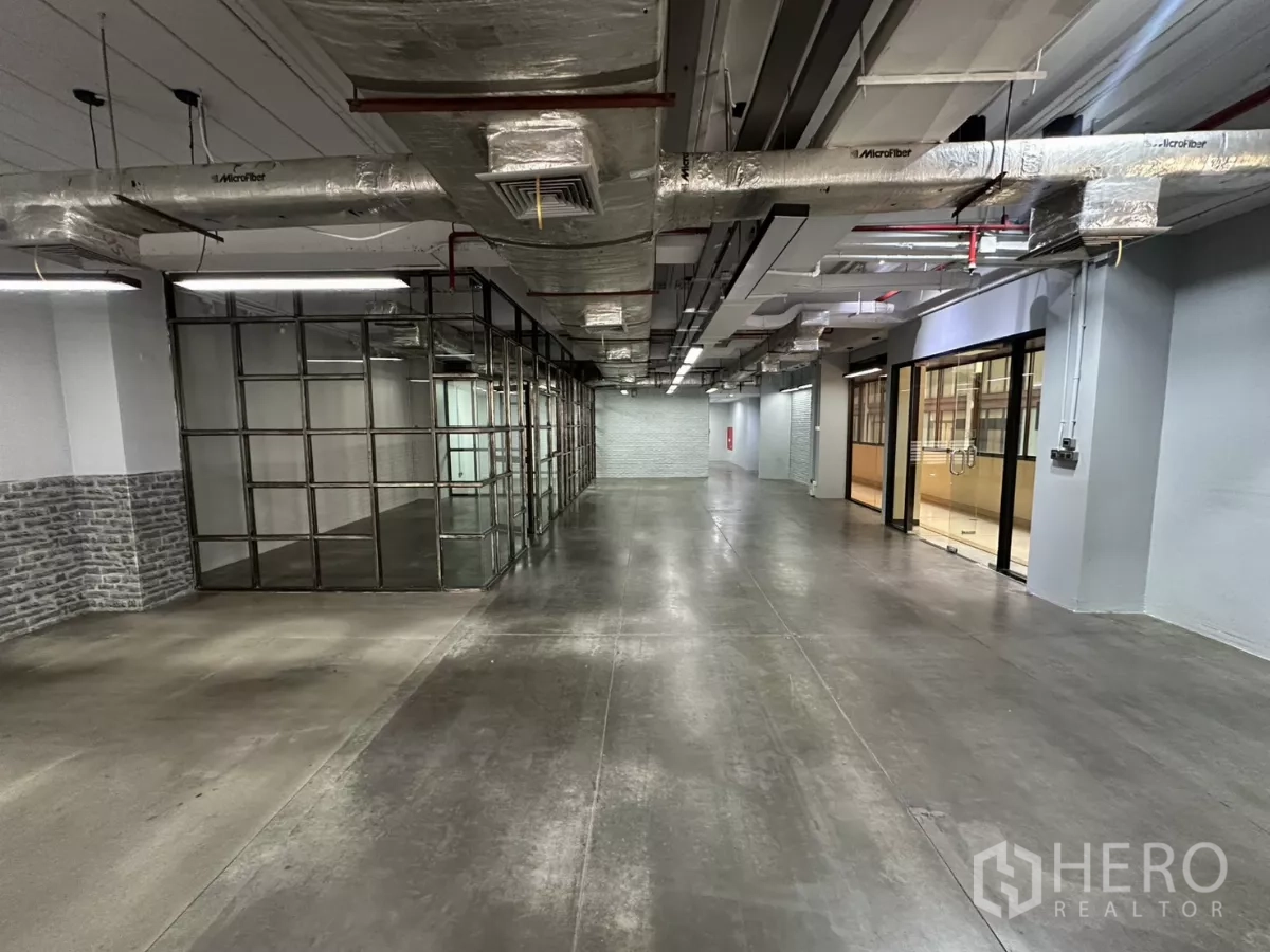 Office Space for rent - Open-plan loft office with polished concrete floors, glass meeting rooms and exposed ducting.