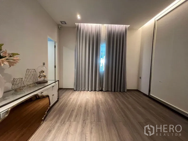 Detached House for sale - Spacious multipurpose room with wood floors, tall curtains and side cabinet ready for study or guest room.