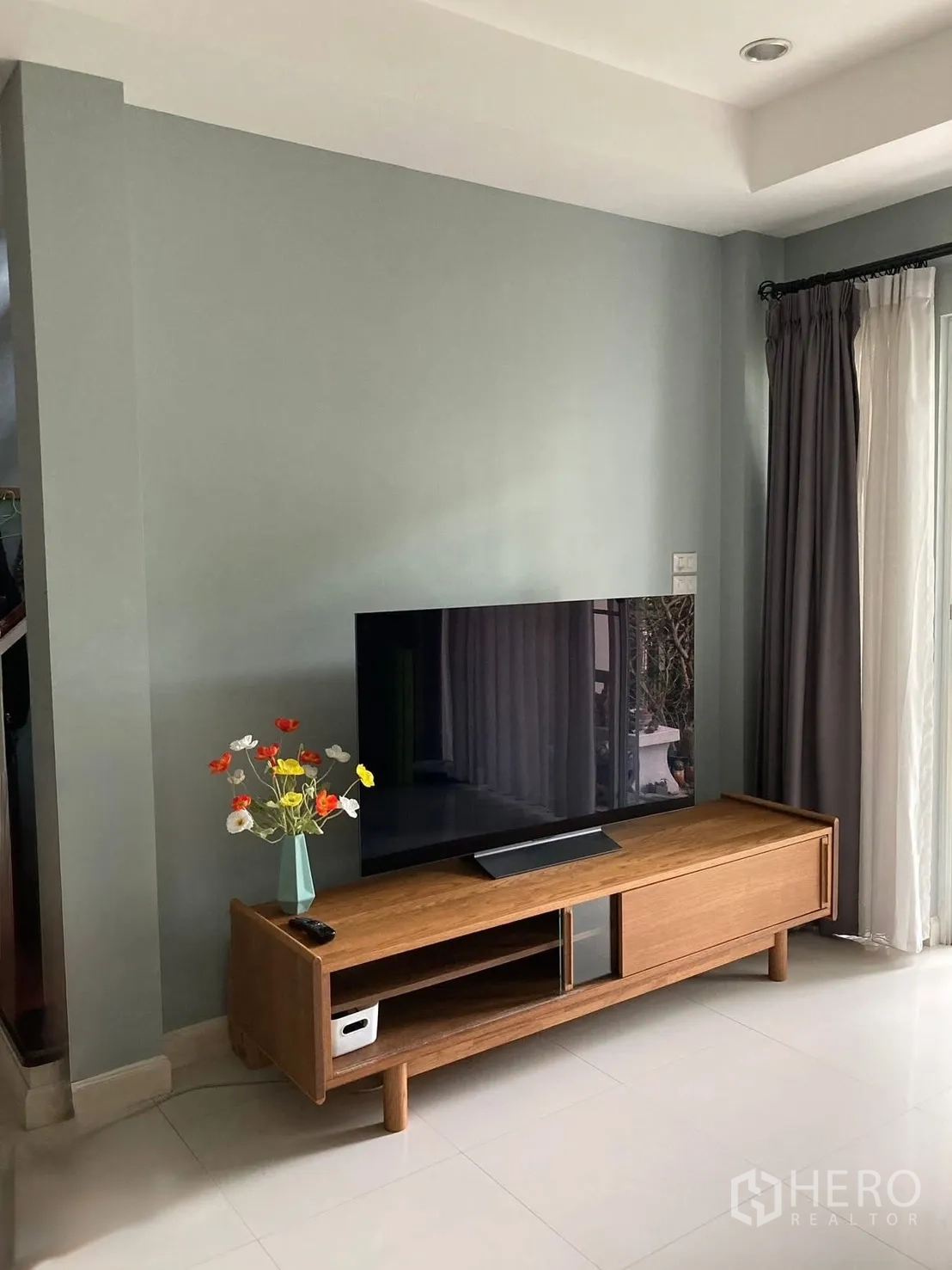 Detached House for rent in Prawet, Bangkok - TV corner with wooden media console and large flat-screen television.