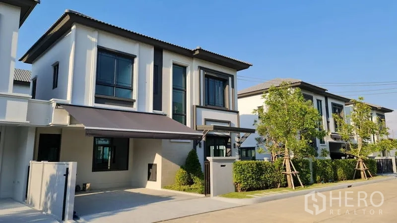 Detached House for rent in Samut Prakan - Row of contemporary houses along a quiet internal street in the estate.