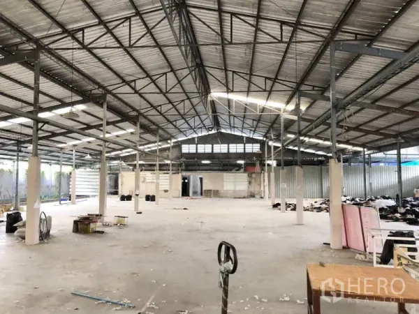 Warehouse for rent or sale in Khlong Luang, Pathum Thani - Open-plan warehouse interior with wide-span roof and rear loading access.