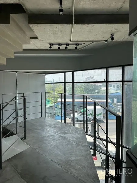 Home Office for rent or sale in Prawet, Bangkok - Mezzanine workspace with large glass curtain walls overlooking the neighborhood.