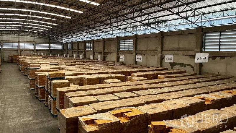 Factory for rent or sale in Pathum Thani - Warehouse bay with ventilation windows and rows of labeled pallets.