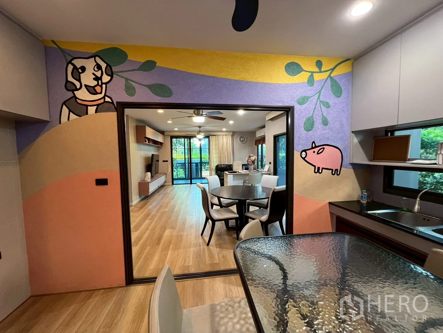 Detached House for rent in Bang Kapi, Bangkok - Pantry view toward living room with playful mural and dining set.