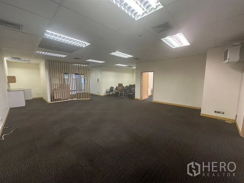 Office Space for rent in Bang Na, Bangkok - Spacious office area featuring a wooden slat partition and stacked chairs.