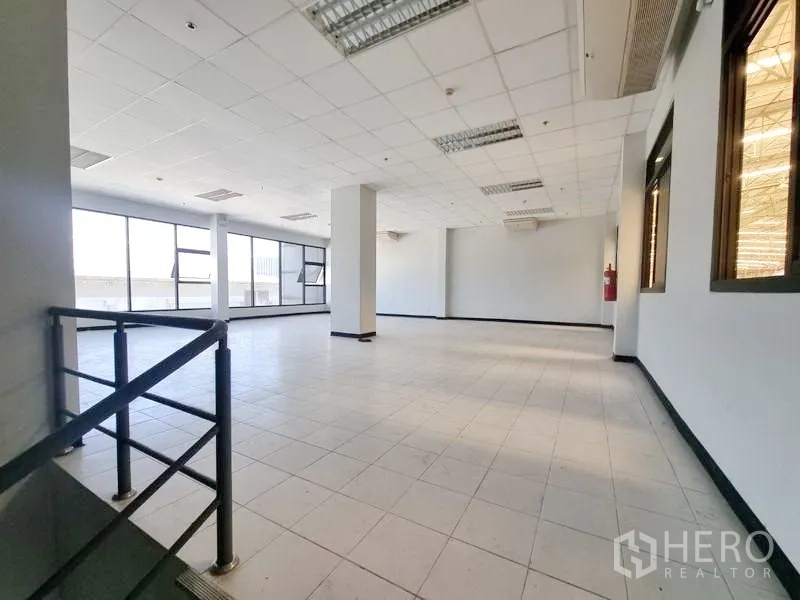 Factory for rent in Bang Pakong, Chachoengsao - Bright upper-floor office area with tiled flooring, drop ceiling, and large windows.