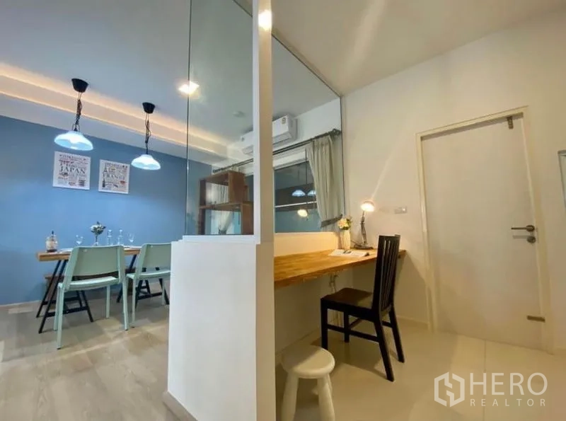 Townhouse for rent in Bang Phli, Samut Prakan - Dining area with pendant lights and a work-from-home nook behind a glass partition.