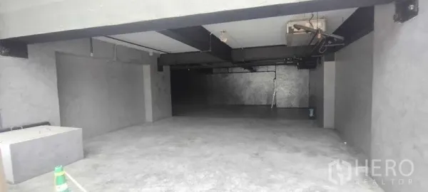 Office Space for rent in Chatuchak, Bangkok - Open-plan concrete office interior with polished floor, exposed ceiling beams and utility lines.