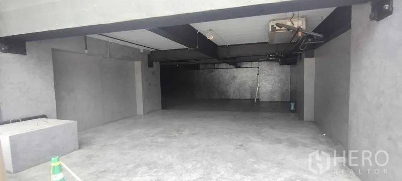 Office Space for rent in Chatuchak, Bangkok - Open-plan concrete office interior with polished floor, exposed ceiling beams and utility lines.