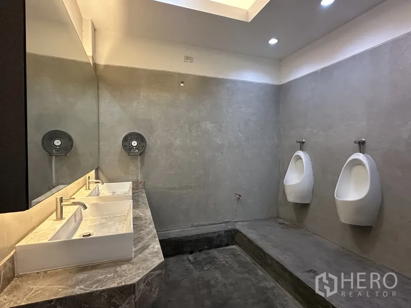 Retail Space for rent in Bang Rak, Bangkok - Restroom with urinals, vessel sinks, and concrete-style finishes.