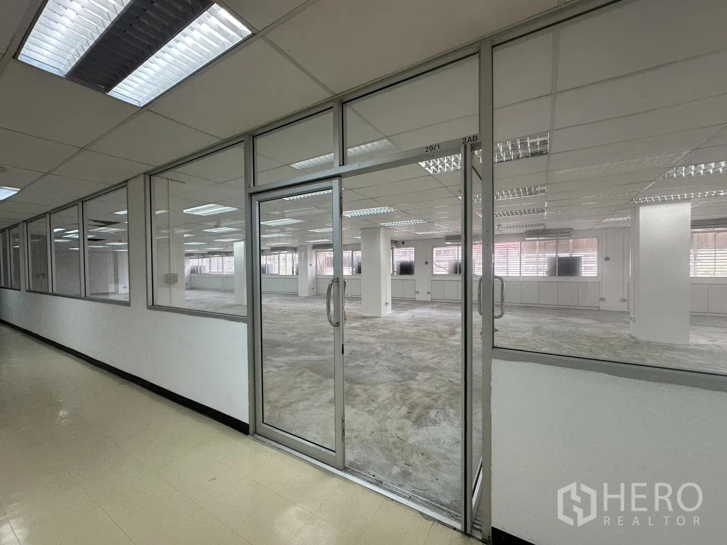 Office Space for rent in Pathum Wan, Bangkok - Hallway view of the office suite with full-height glass frontage and double doors.