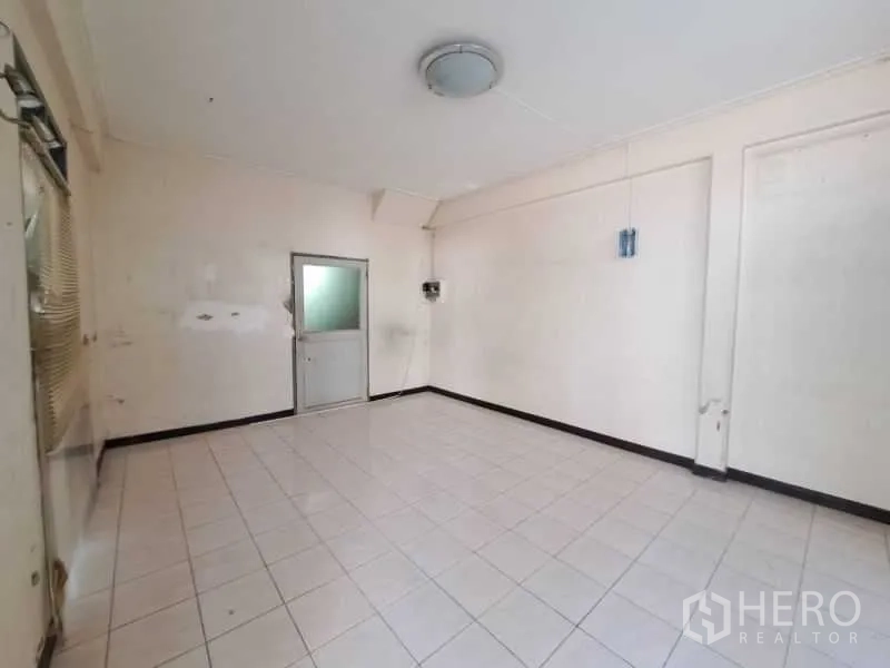 Retail Space for rent in Sathon, Bangkok - Clean square room with tiled floor and a rear door for storage or staff.