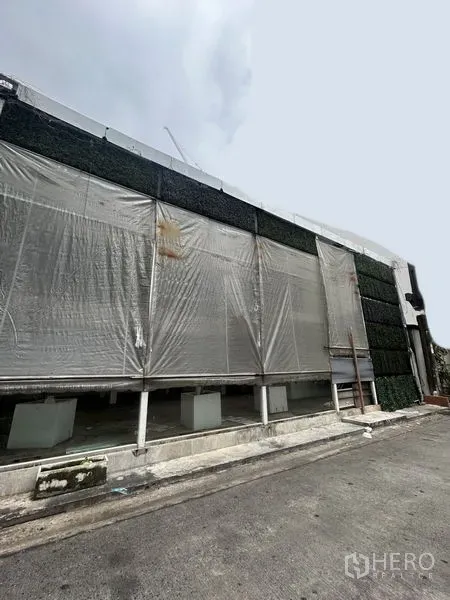 Retail Space for rent in Khlong Toei, Bangkok - Street-side view of a wide shopfront with roll-up transparent screens and signage-ready frontage.
