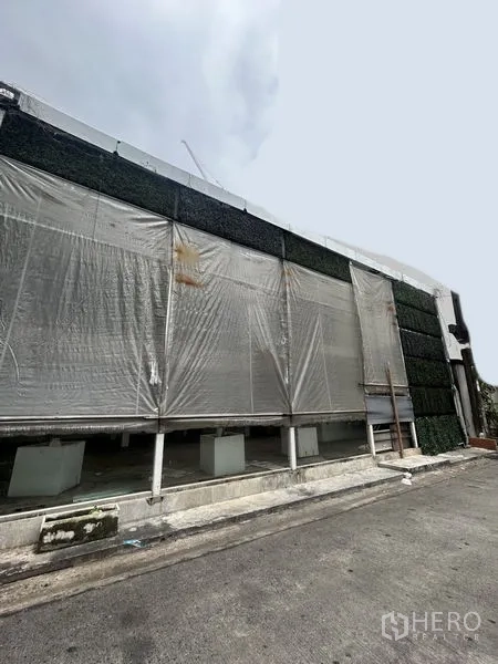 Retail Space for rent in Khlong Toei, Bangkok - Street-side view of a wide shopfront with roll-up transparent screens and signage-ready frontage.