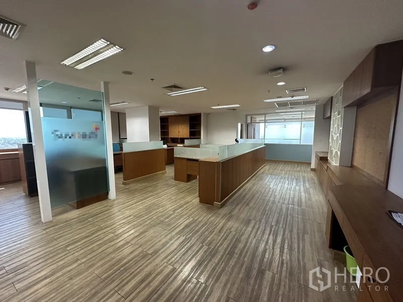 Office Space for rent or sale - Large work zone with frosted-glass dividers and island-style desks.