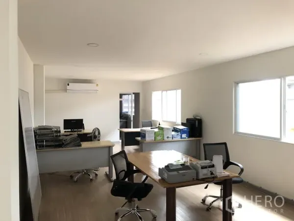 Warehouse for rent in Nonthaburi - Bright office room inside the warehouse with desks, chairs, windows and air conditioning.