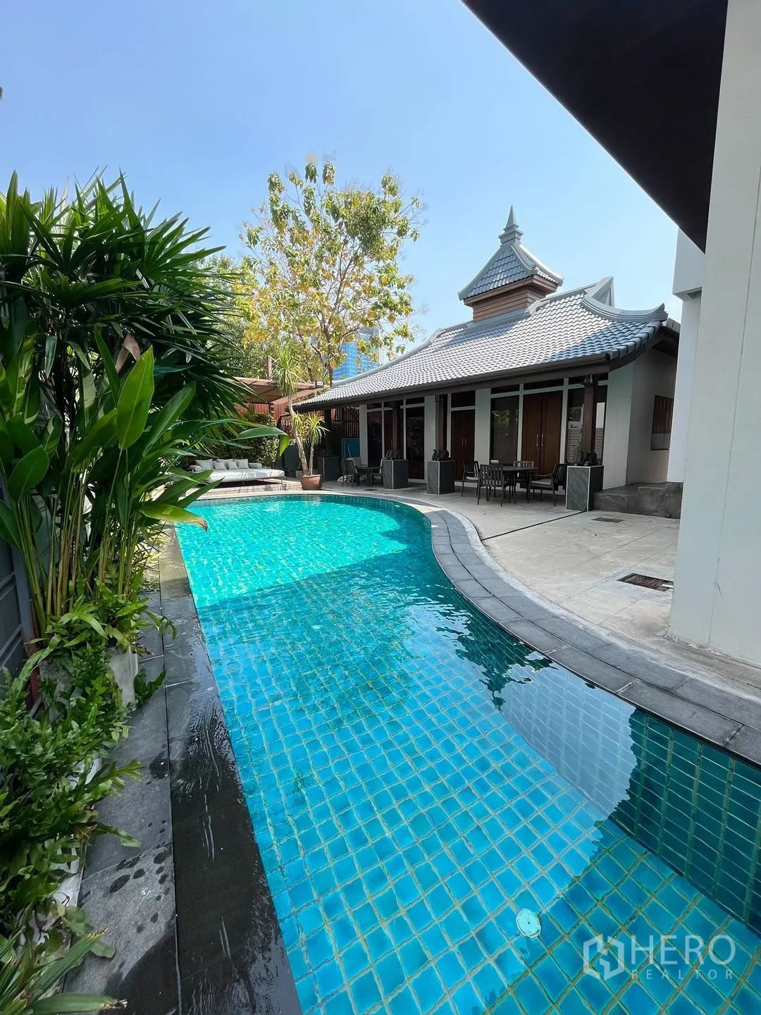 Detached House for rent in Watthana, Bangkok - Long tiled swimming pool beside terrace and pavilion.