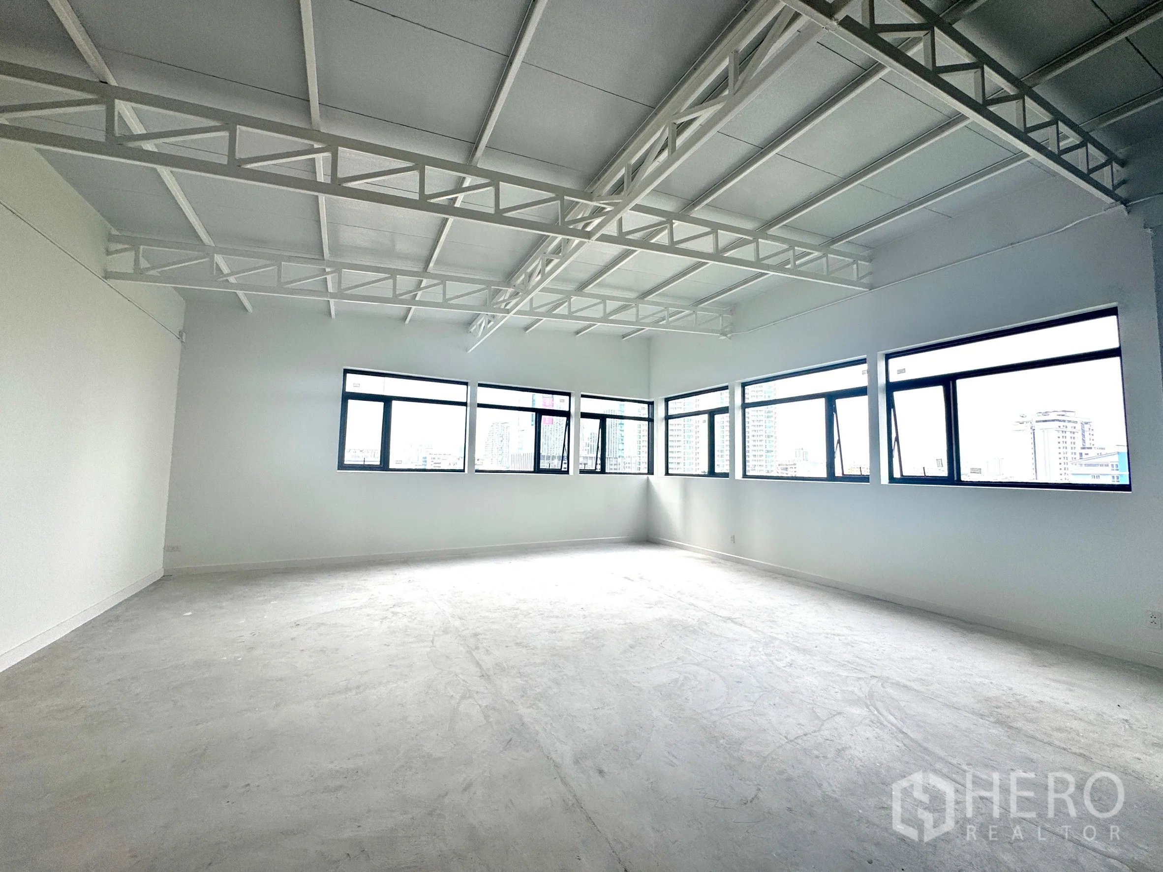 Office Space for rent in Sathon, Bangkok - Spacious open-plan office with high truss ceiling and multiple large windows.
