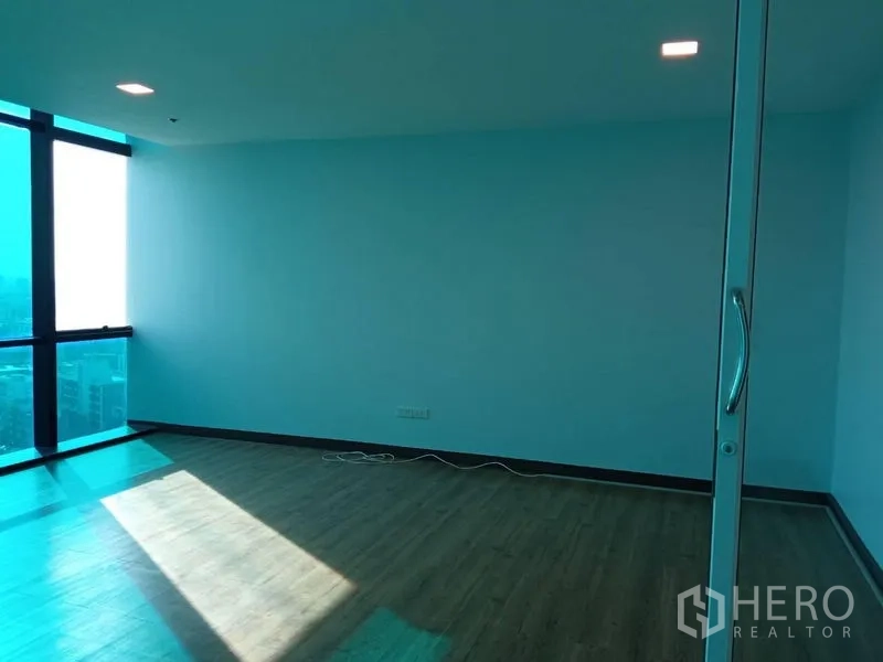 Office Space for rent in Huai Khwang, Bangkok - Glass-partitioned room with large windows, wooden floor, and natural light for a private office or meeting space.