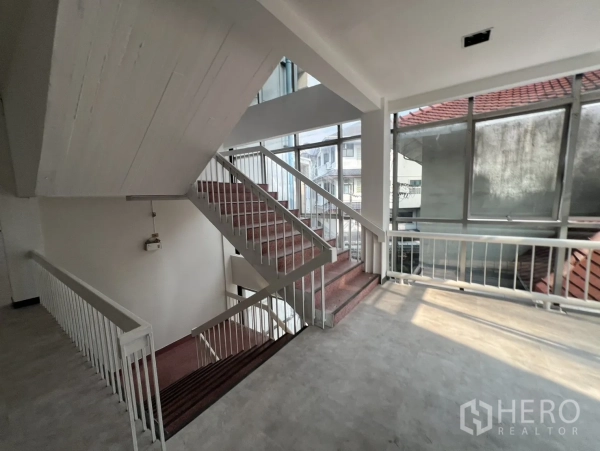 Office Space for rent in Watthana, Bangkok - Stairwell landing with big glazing and white railings bringing daylight into the office.