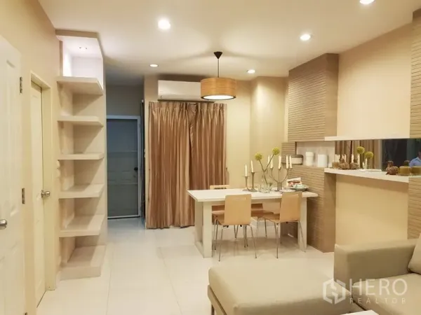 Townhouse for rent in Phra Khanong, Bangkok - Bright dining space with pendant light, built-in shelving and air conditioning.