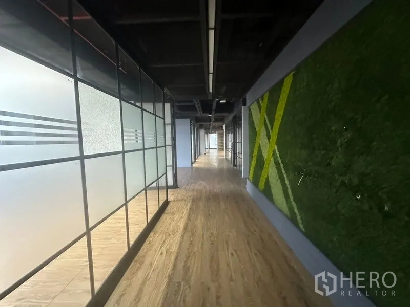 Office Space for rent in Bang Rak, Bangkok - Long hallway with frosted glass and wood floors in a contemporary office.