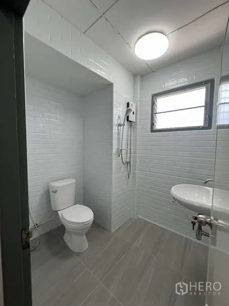 Detached House for rent in Bang Na, Bangkok - Bathroom with glass shower, white subway tiles and a ventilating window.