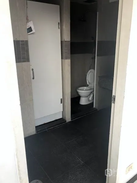Office Space for rent in Watthana, Bangkok - Office restroom with toilet and shower area in neutral tiles.