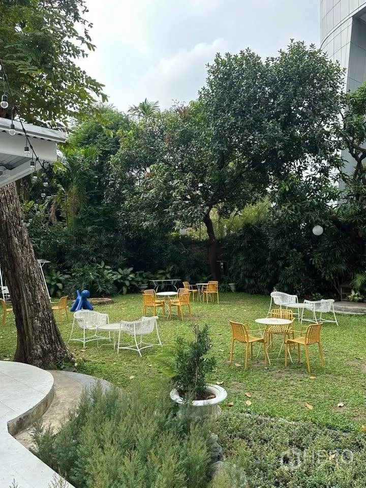Retail Space for rent in Khlong Toei, Bangkok - Lush garden lawn shaded by mature trees with multiple cafe-style tables and chairs.