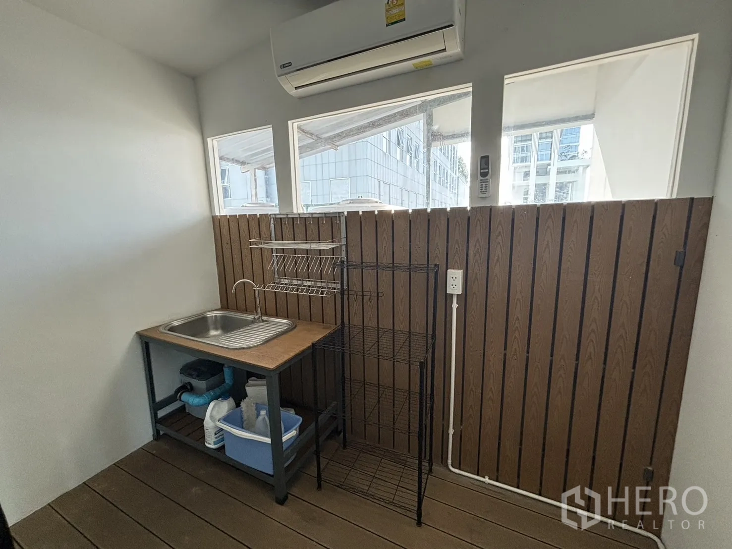 Office Space for rent in Watthana, Bangkok - Pantry corner with stainless sink, storage rack and air conditioner.