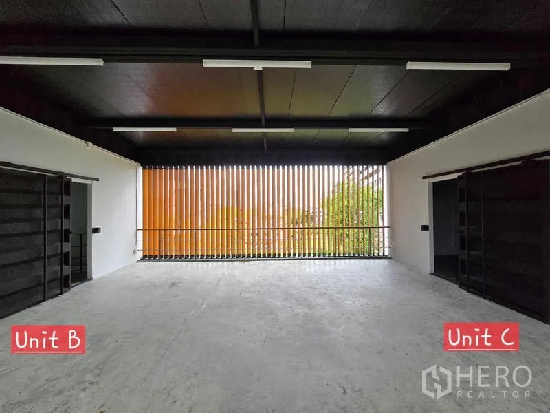 Home Office for rent in Chatuchak, Bangkok - Open-plan home office floor with black ceiling and vertical orange slat screen bringing in natural light.