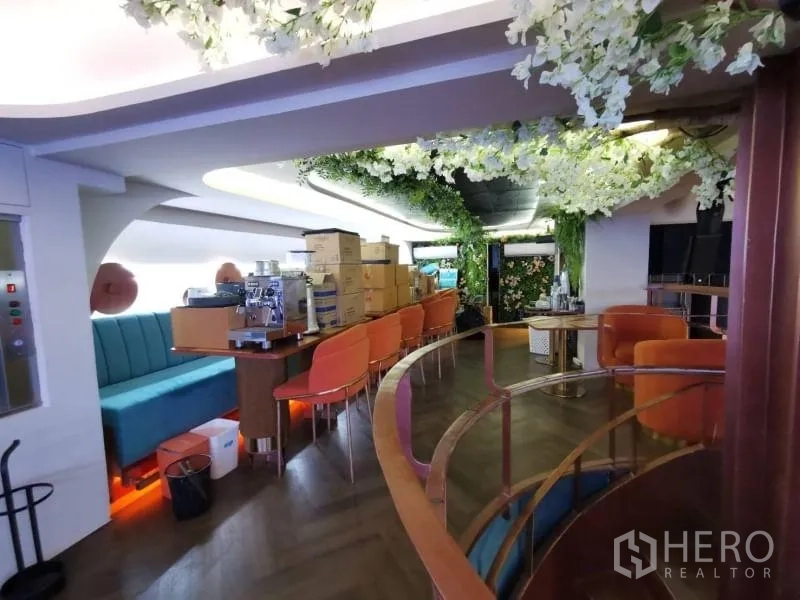 Retail Space for rent - Mezzanine bar with long banquette, counter seating, and floral ceiling decor.