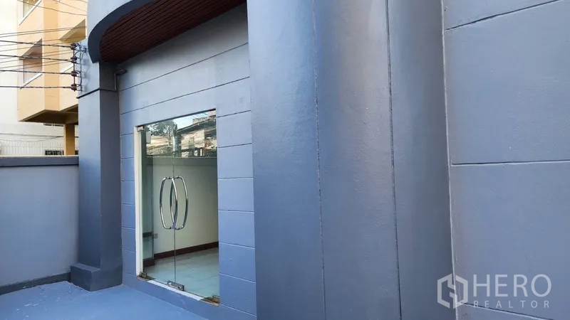 Office Space for rent or sale in Khlong Toei, Bangkok - Street-level facade with curved canopy and a glass entry door.