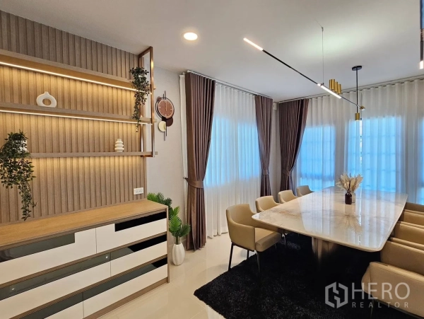 Detached House for rent or sale in Bang Phli, Samut Prakan - Dining corner with accent shelving, pendant lighting and wide curtained windows.