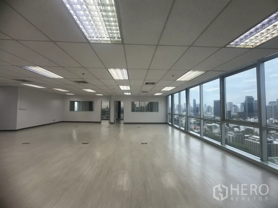 Office Space for rent in Khlong Toei, Bangkok - Spacious open-plan office with full-height windows and Bangkok skyline views.
