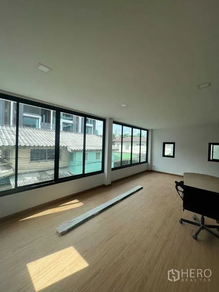 Home Office for sale - Bright corner workspace with floor-to-ceiling windows and wood-look flooring overlooking the neighborhood.