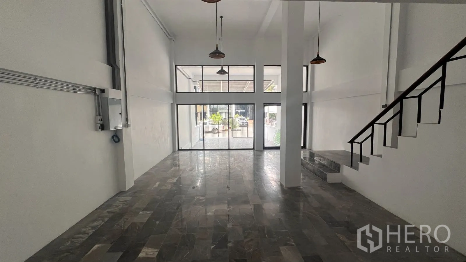 Home Office for rent or sale in Phra Khanong, Bangkok - Double-height lobby with pendant lights and a side staircase.