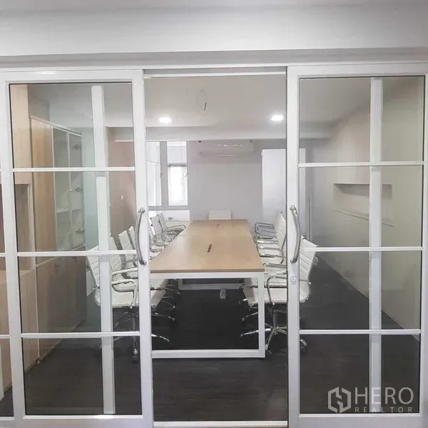 Home Office for rent or sale in Suan Luang, Bangkok - Meeting room viewed through white-framed sliding glass doors.