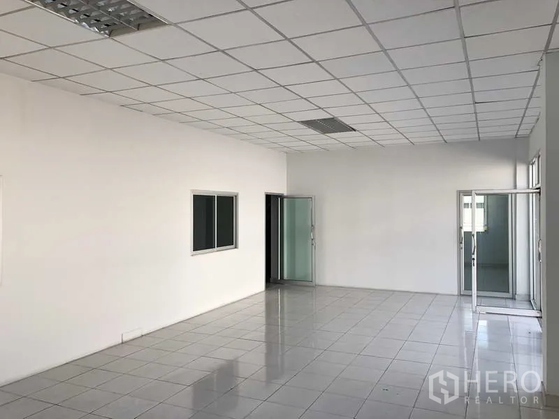 Warehouse for rent in Phra Nakhon Si Ayutthaya - Ground‑floor office lobby with glass entry, staircase and white tiled flooring.